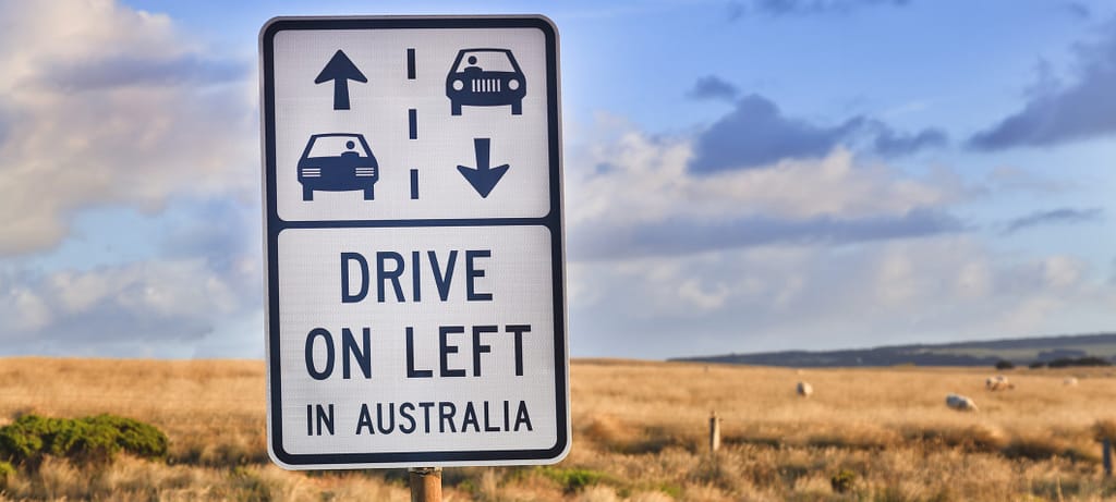 Australian outback road sign "drive on left in australia" as a reminder for overseas tourists about road safety on Great Ocean Road