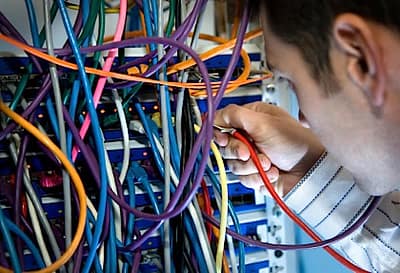 IT technician working at network server computers