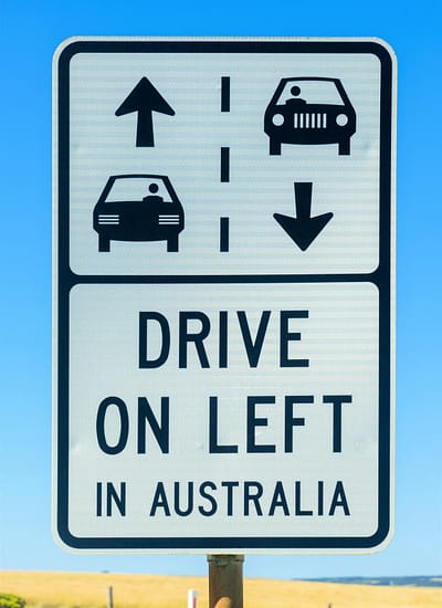 Australian road sign with arrows and drive on left message to remind tourists about road safety on Great Ocean Road, Victoria