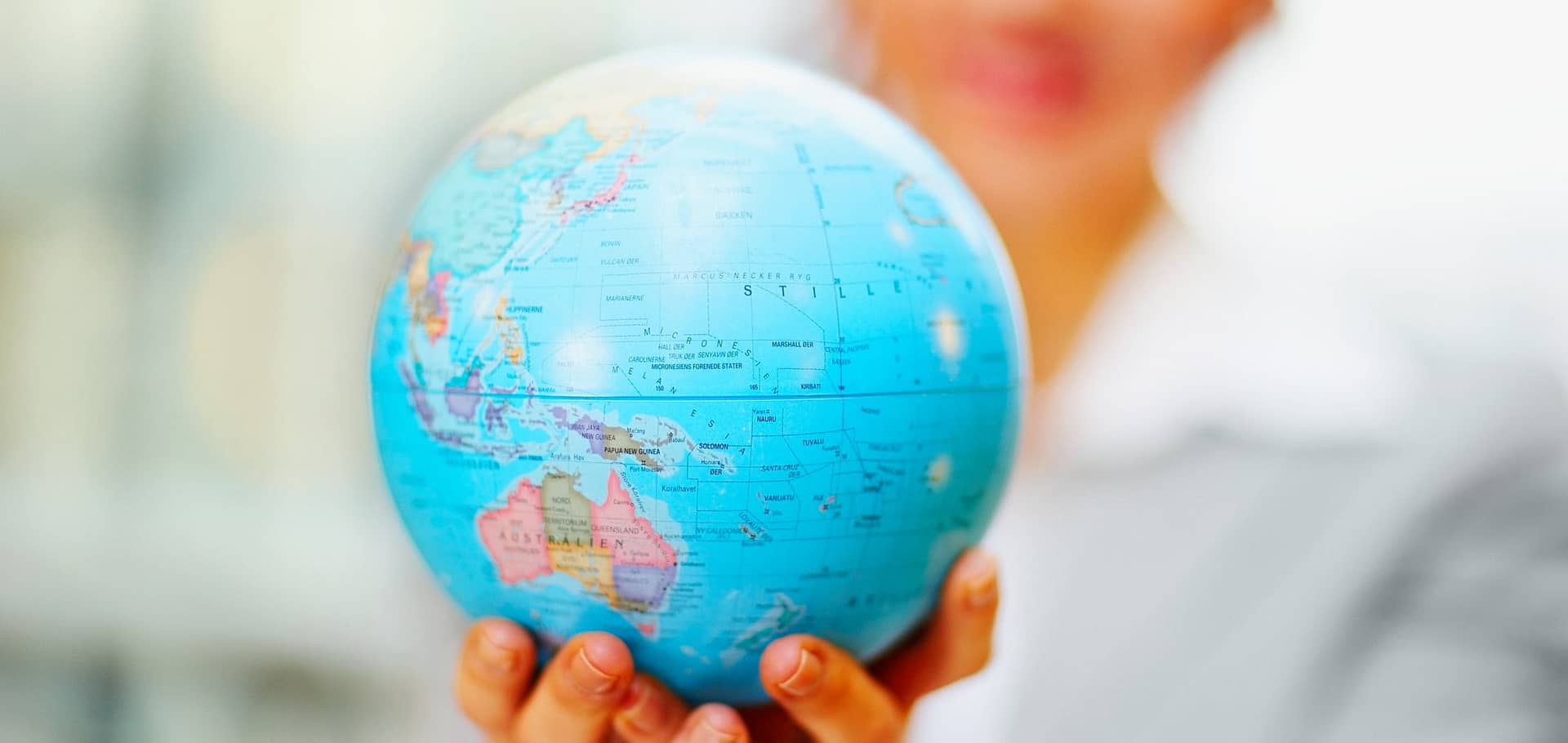 Business woman holding a globe in the hand, focus on globe